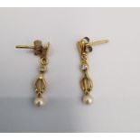 A pair of yellow metal (tests higher than 9ct) cultured pearl and diamond drop earrings. Each