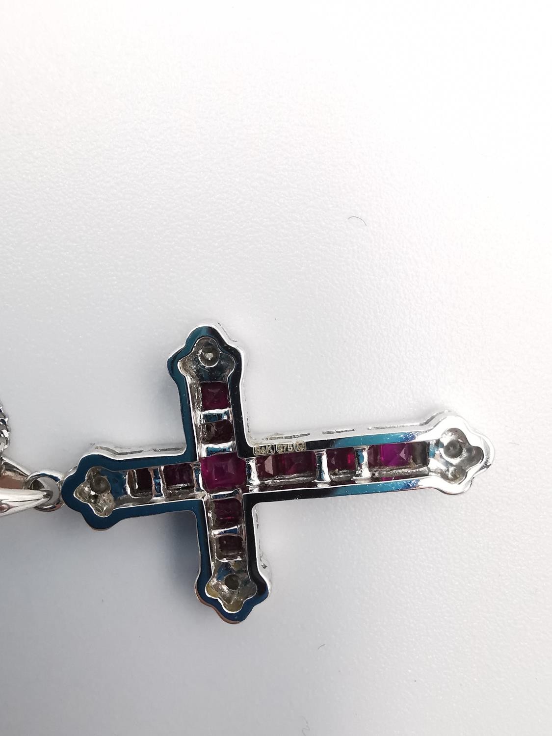 A boxed 9ct white gold ruby and diamond cross and chain. The cross set with twelve square channel - Image 6 of 7