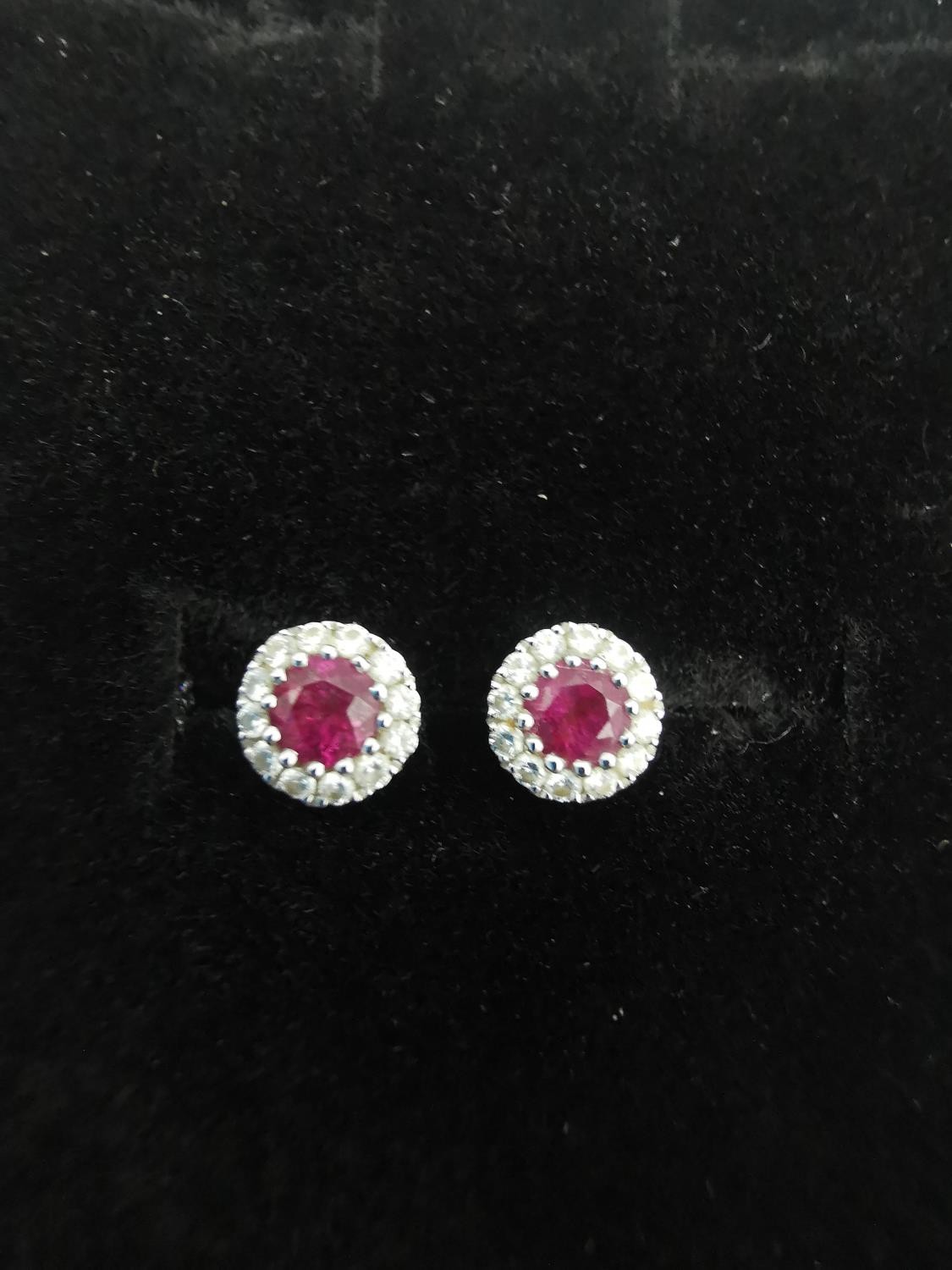 A pair of 18ct white gold ruby and diamond cluster stud earrings. Each set to centre with a round - Image 5 of 6