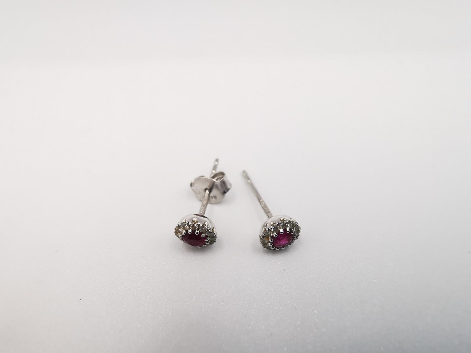 A pair of 18ct white gold ruby and diamond cluster stud earrings. Each set to centre with a round - Image 3 of 6