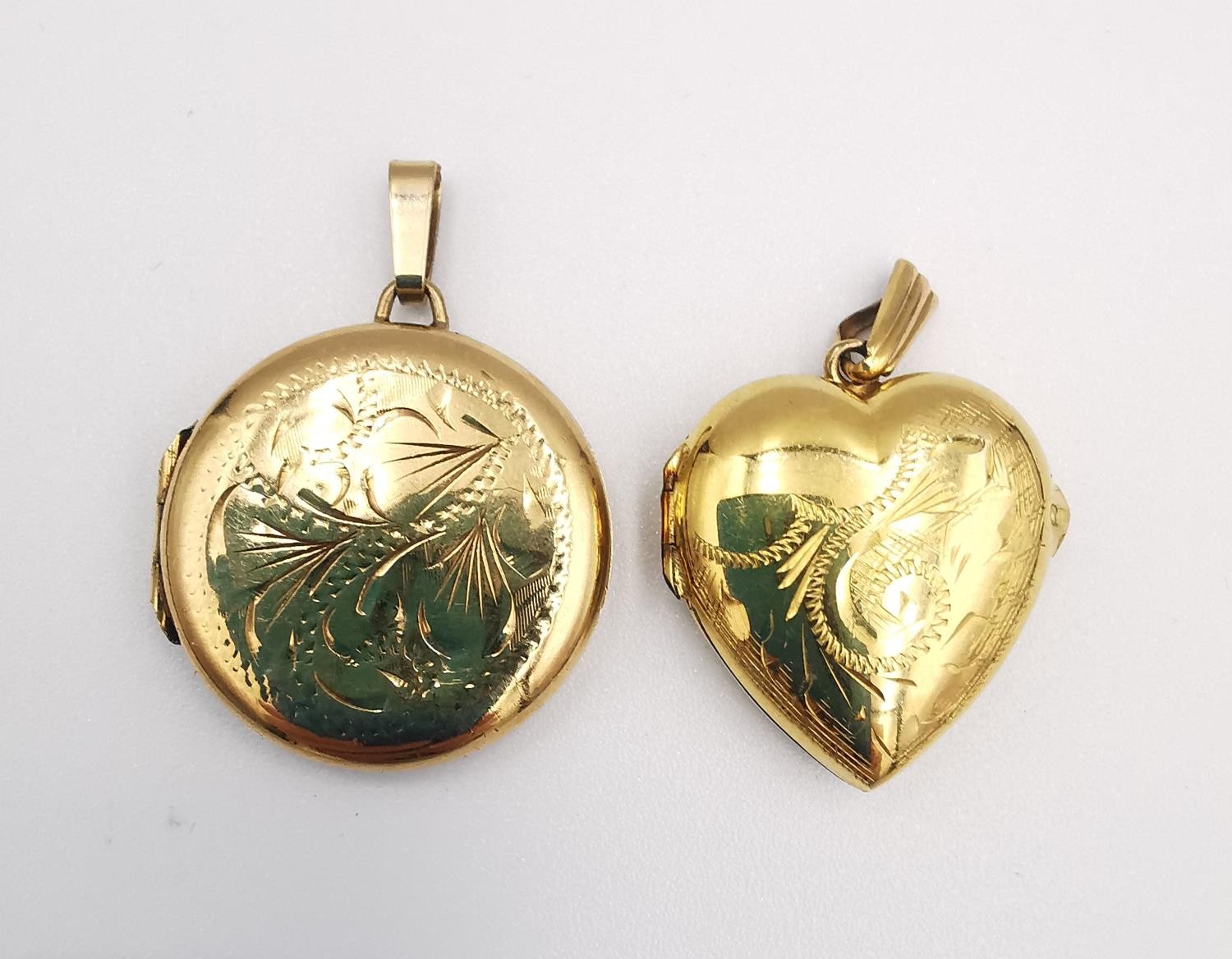 Two engraved 9ct yellow gold lockets. One heart shaped by Georg Jensen with a stylised scrolling