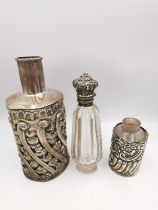 Three silver perfume bottles, one cut crystal with hinged silver repousse top set with turquoise and