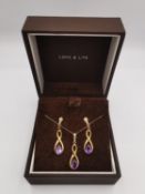 A 9ct rose gold and amethyst pendant with chain and earrings set. The infinity design pendant set