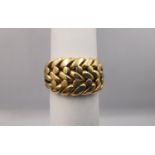 A Victorian 18 carat yellow gold keeper ring with plaited design, tri-strand trumpeting shoulders