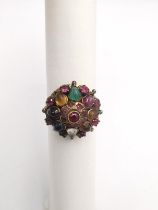A yellow metal (tests as 9ct) gem set Indian dress ring, set with rubies, emerald, Citrine,