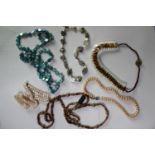 A collection of six mixed cultured pearl necklaces, including a dyed blue circular fresh water pearl