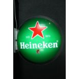 A wall mounted illuminated Heineken sign. Dia. 70 cm.