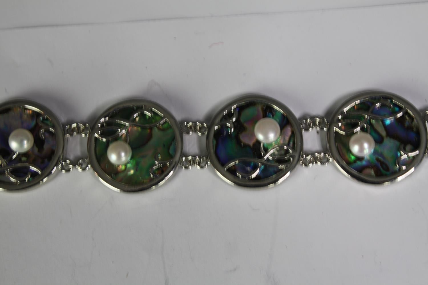 A collection of six cultured pearl bracelets of various designs, including a blue enamel and white - Image 5 of 6