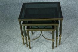 Occasional tables, a nest of three vintage in brass and smoked glass. H.47 L.56 W.46cm. (largest)