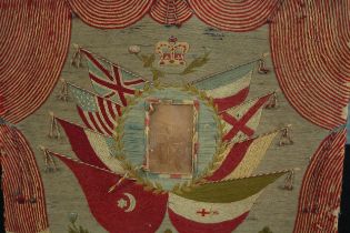 Patriotic embroidery with a military portrait at the centre. The artwork is nicely faded but much of