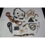 A collection of jewellery, including a frog and snail brooch, a Tibetan agate bead necklace, a