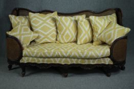 Bergere sofa, mid century mahogany framed in the French Provincial style, reupholstered and with