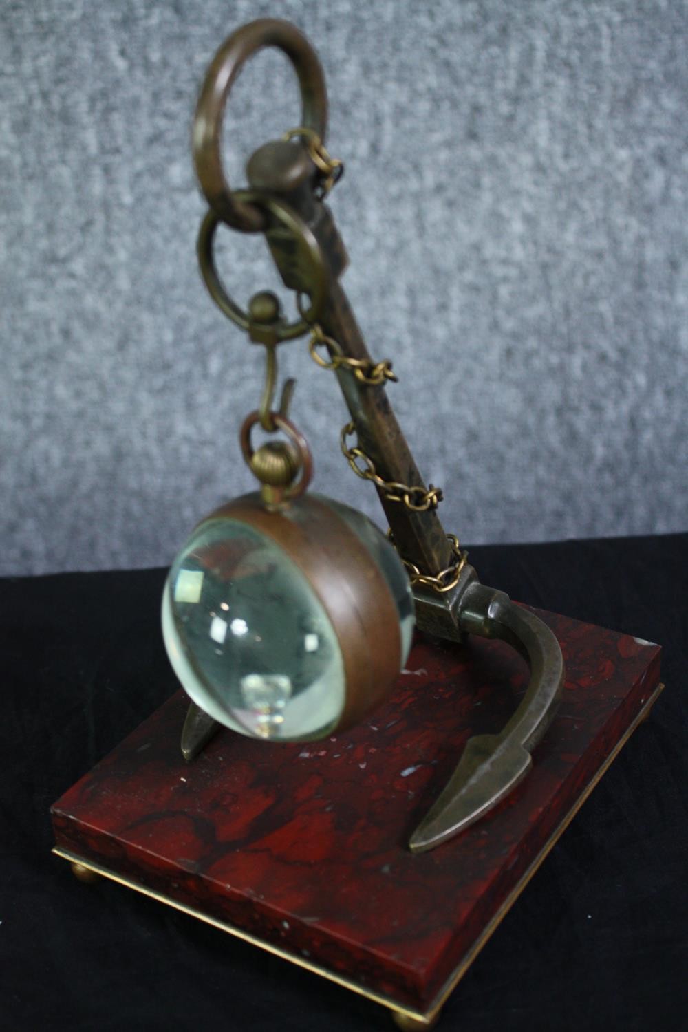 A glass ball suspended by an anchor. The glass ball would once have held a clock. Not present. Also, - Image 5 of 6