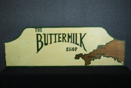 A hand painted sign. 'The Buttermilk Shop'. Decorated with the county of Cornwall. H.61 W.180 cm.