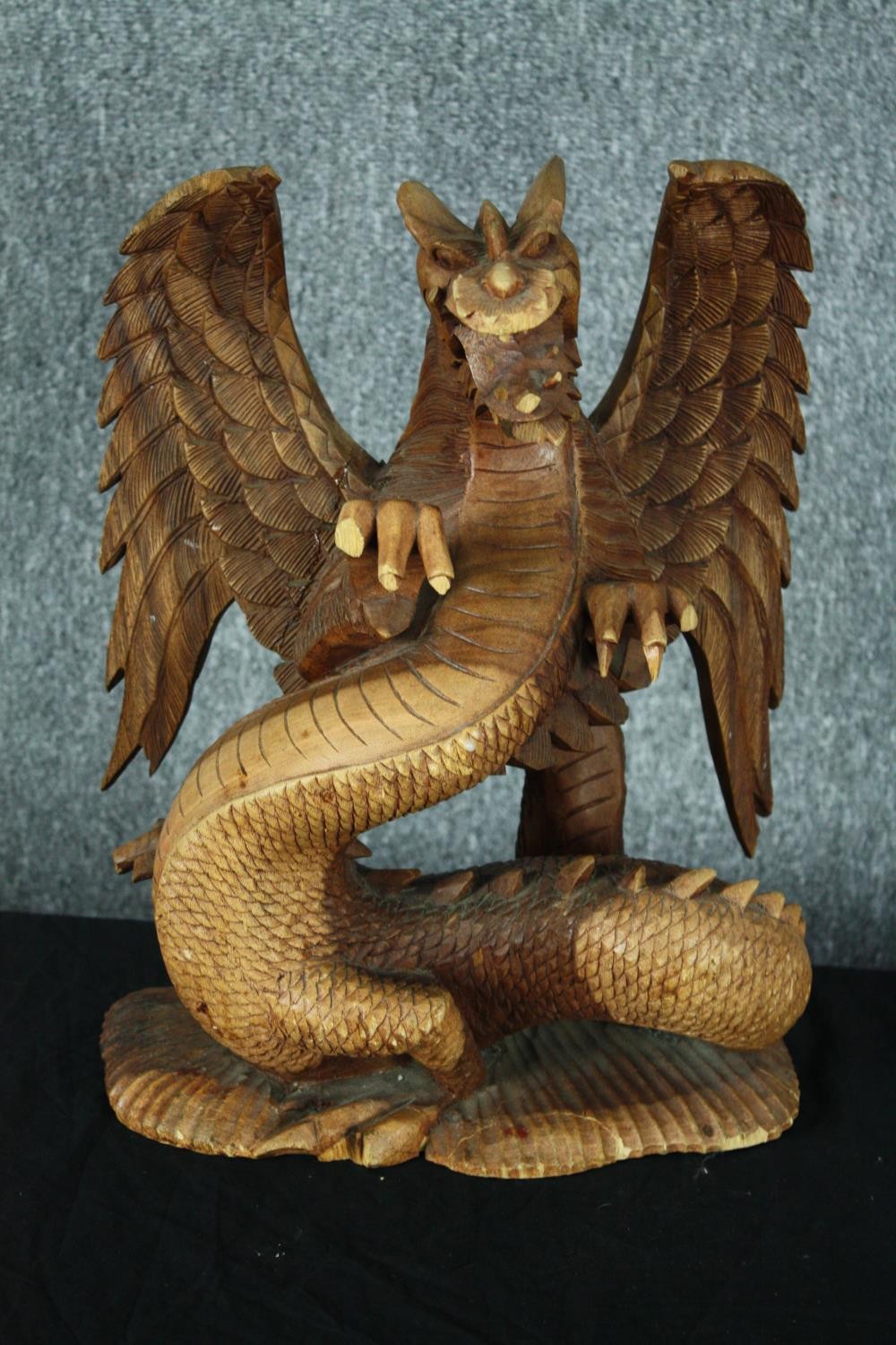 A carved Chinese dragon. Highly detailed with intricate scales and fangs. Twentieth century. H.44cm.