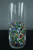 A collection of various sized marbles. In a glass vase. Dia.18 cm.