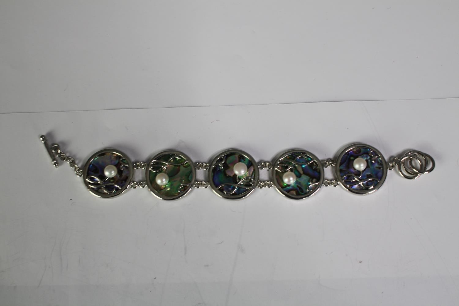 A collection of six cultured pearl bracelets of various designs, including a blue enamel and white - Image 6 of 6