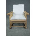A contemporary Arts and Crafts style oak framed reclining armchair. H.86 W.77 D.86cm.