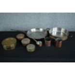 A mixed collection of brass and copper kitchen ware. Including a frying pan, and coffee jugs. H.7