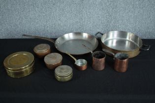 A mixed collection of brass and copper kitchen ware. Including a frying pan, and coffee jugs. H.7