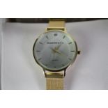 A boxed Diamond and Co ladies quartz watch with gold tone mesh strap and white dial. Box and papers.