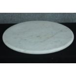 A large round marble cutting board with a diameter of 60 cm.