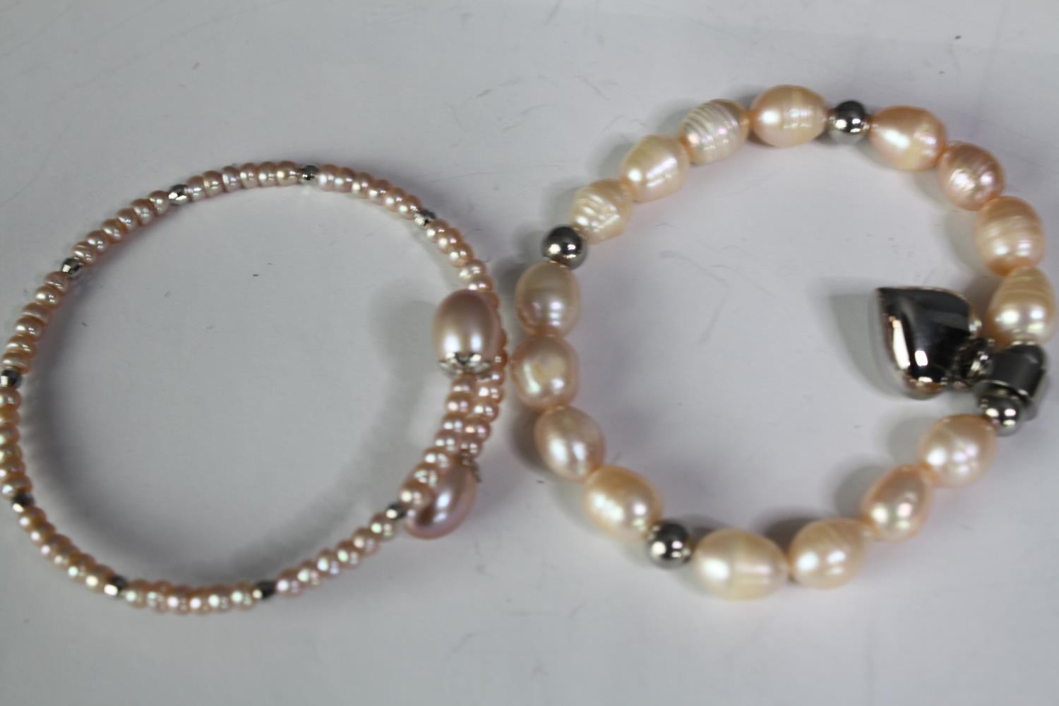 A collection of six cultured pearl bracelets of various designs, including a blue enamel and white - Image 3 of 6