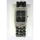 A boxed Geona fashion watch with faux black pearl elastic strap and diamante stones to the face