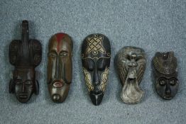 A miscellaneous collection of five Eastern and Tribal masks. H.60cm. (largest)