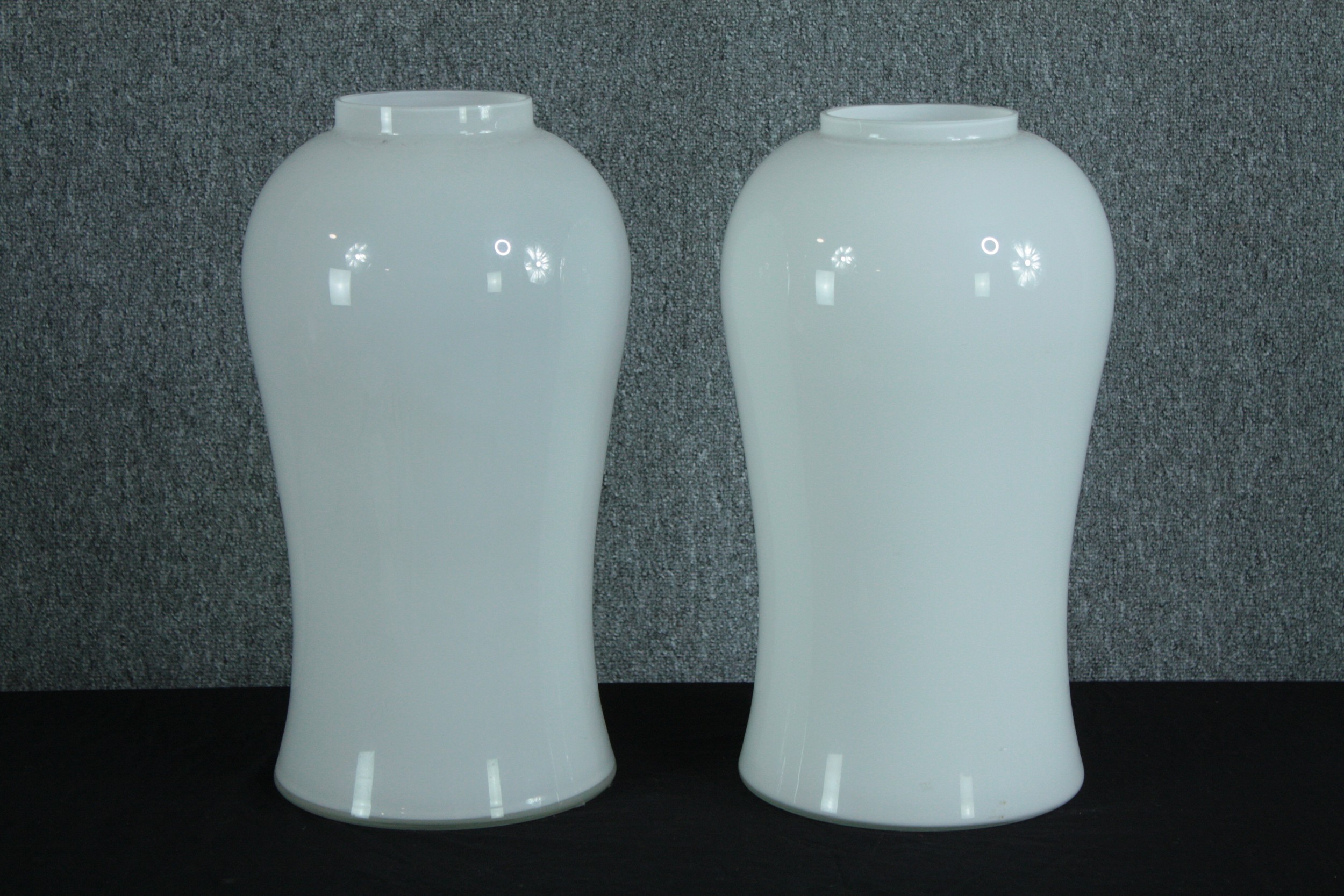 Ingo Maurer, (1932-2019), pair of Mid-century white glass lamps in the shape of a vase. Makers label
