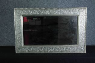 Wall mirror, embossed metal frame. H.62 W.94cm.