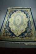 Carpet, deep pile woollen, central pendant medallion on sapphire ground within scrolling foliate