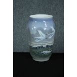 Royal Copenhagen. Vase dated 1955 at the base. Decorated with swans in flight. H.26 Dia.16 cm.