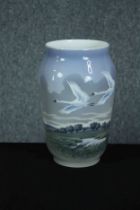 Royal Copenhagen. Vase dated 1955 at the base. Decorated with swans in flight. H.26 Dia.16 cm.
