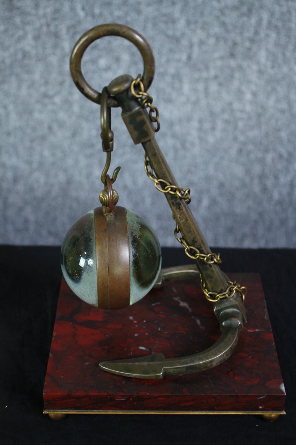 A glass ball suspended by an anchor. The glass ball would once have held a clock. Not present. Also, - Image 4 of 6