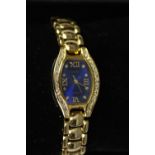 Two boxed fashion watches, one with a gold tone articulated bracelet, midnight blue face and