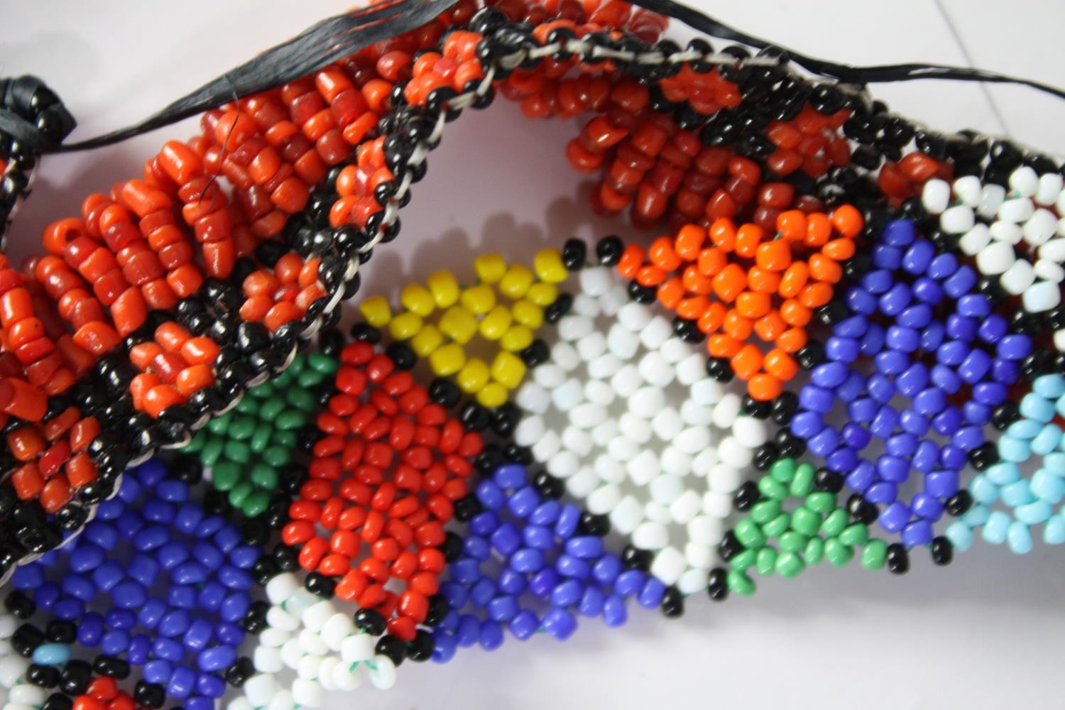 A collection of African tribal coloured seed bead jewellery, including a multi coloured zig zag - Image 6 of 9