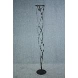 A floor standing decorative iron candle holder. H.170cm.