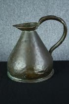A copper jug. Well used and probably early twentieth century. H.33 cm.