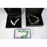 Three boxed statement gem set necklaces. A Jasper and black fresh water pearl necklace, a pearl