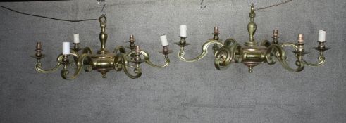 A matching pair of brass eight branch chandeliers with scrolling design. H.36 Dia.83 cm. (each)
