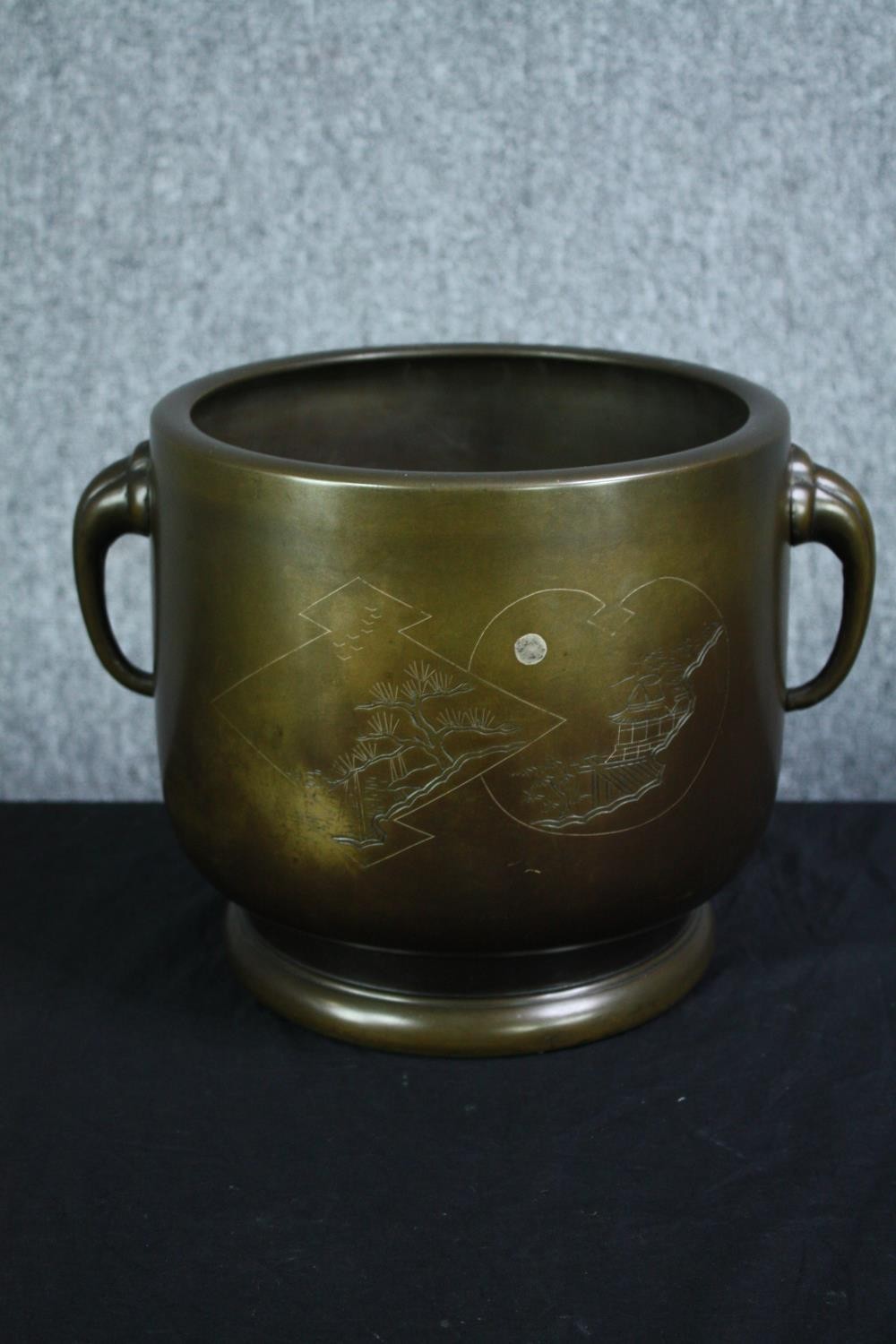 A large Chinese bronze twin handled urn with an etched decoration of pagoda in moonlight. H.23