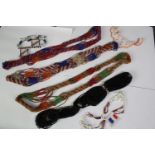 A collection of early 20th century African tribal beaded jewellery, various designs and lengths.