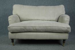 Sofa, contemporary in the Howard style on turned supports with brass cup casters. H.82 W.128 D.90cm.