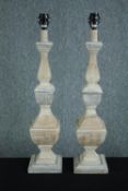 A pair of tall carved, limed and distressed painted table lamp bases. H.74cm. (each)