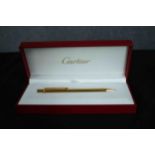 Cartier gold plated ballpoint pen in unused condition and still in original packaging box. Dated