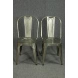A pair of metal vintage industrial style dining chairs.