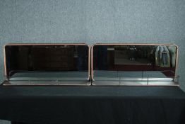 A pair of wall mirrors in gilt metal frames. H.40 W.90cm. (each)