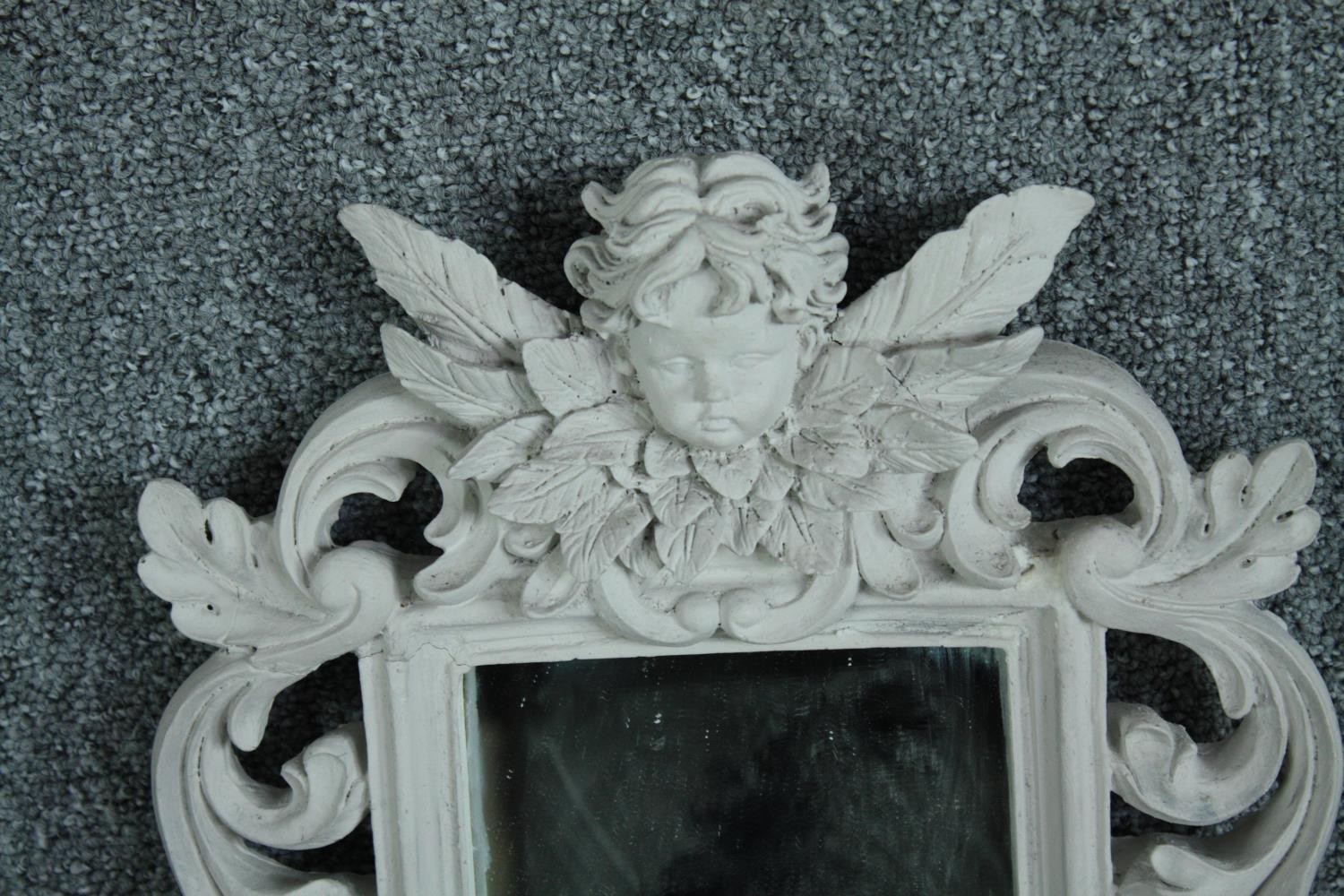 A pair contemporary pier mirrors with floral decorated frames and cherub surmounts. H.80 W.28cm. ( - Image 4 of 5