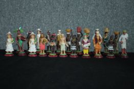 An eclectic mix of twenty two ethnic characters. Hand painted and cast in plaster. H.12cm. (largest)